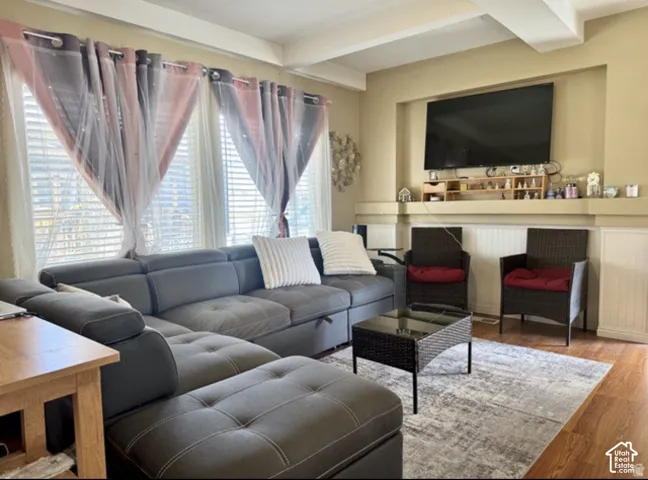 Recessed media niche, coffered ceiling, wood-finish flooring, and wainscoting