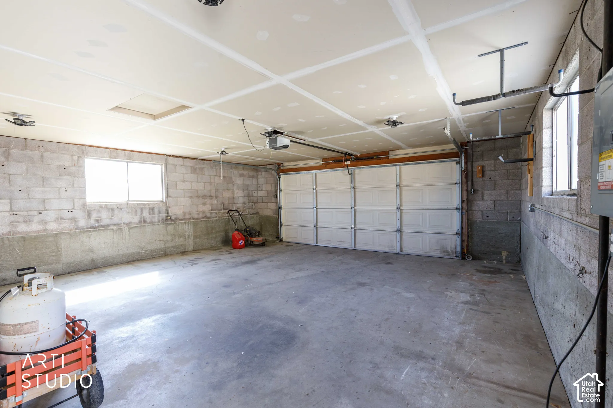 Concrete block construction with exposed piping and a painted concrete floor