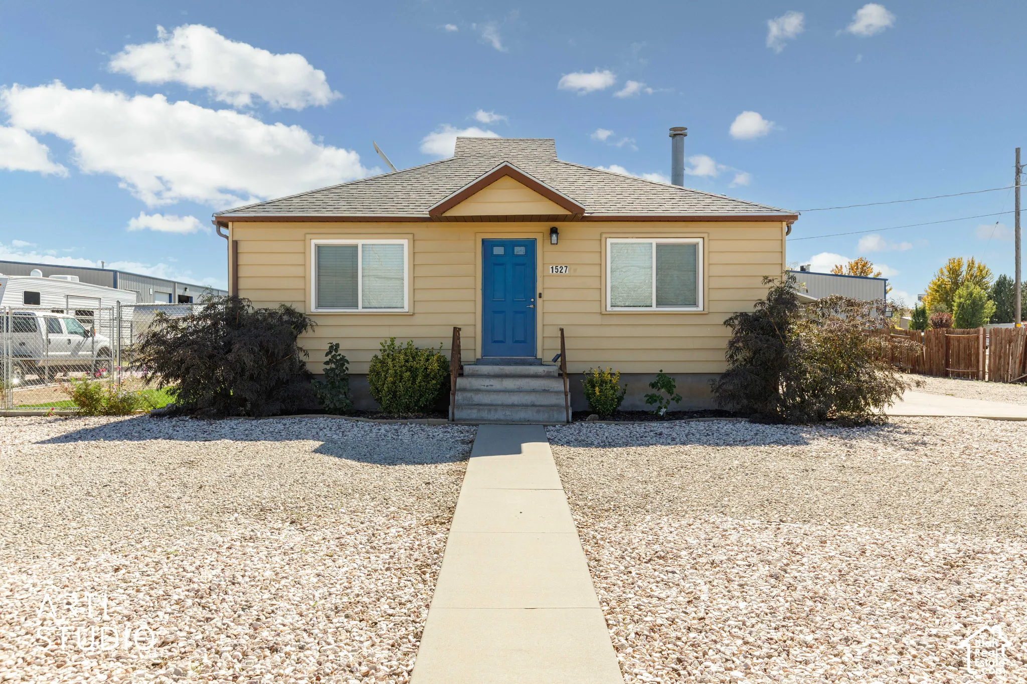 Siding exterior with a brightly colored entry door