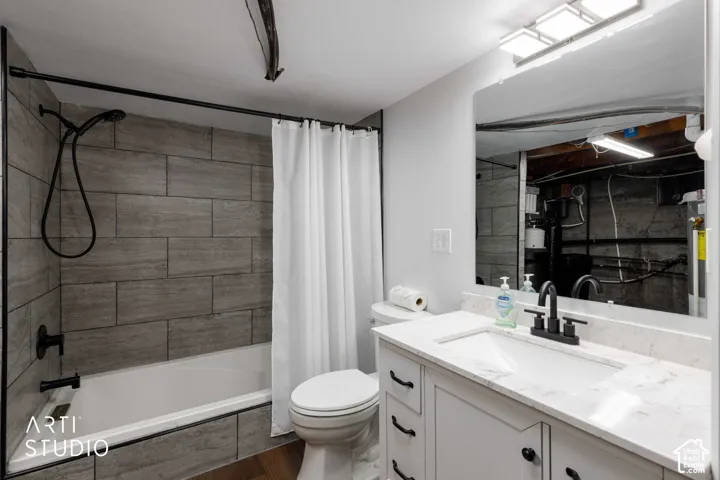 White vanity with a quartz countertop, integrated sink, and matte black faucet