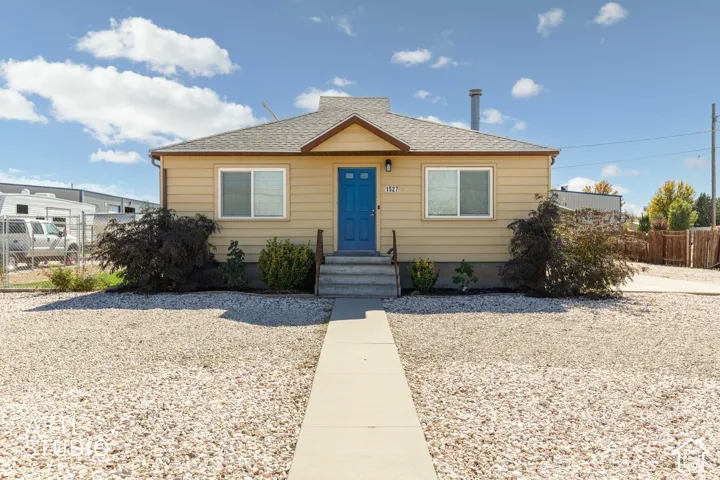 Siding exterior with a brightly colored entry door