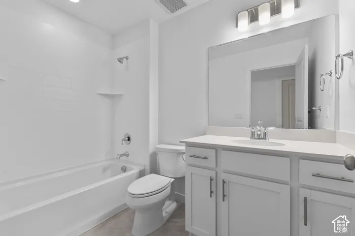 White vanity with shaker-style cabinetry, a single basin sink, and a rectangular mirror