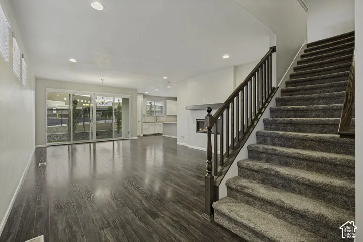 Open-concept living area with dark wood-finish flooring