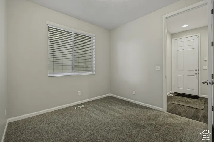 Neutral-toned walls complement the gray carpeting