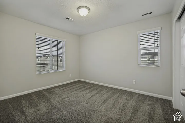 Neutral-toned walls complement the textured carpeting