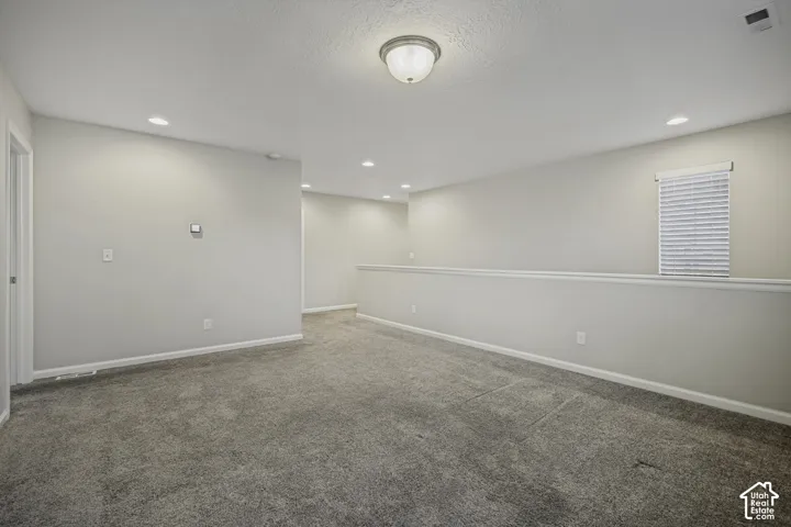 Recessed ceiling lighting, flush mount ceiling fixture, gray wall paint, gray carpet flooring, window with blinds