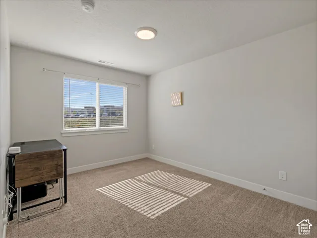 Bedroom #3  Neutral wall paint, carpet flooring, window with blinds, and a flush-mount ceiling light