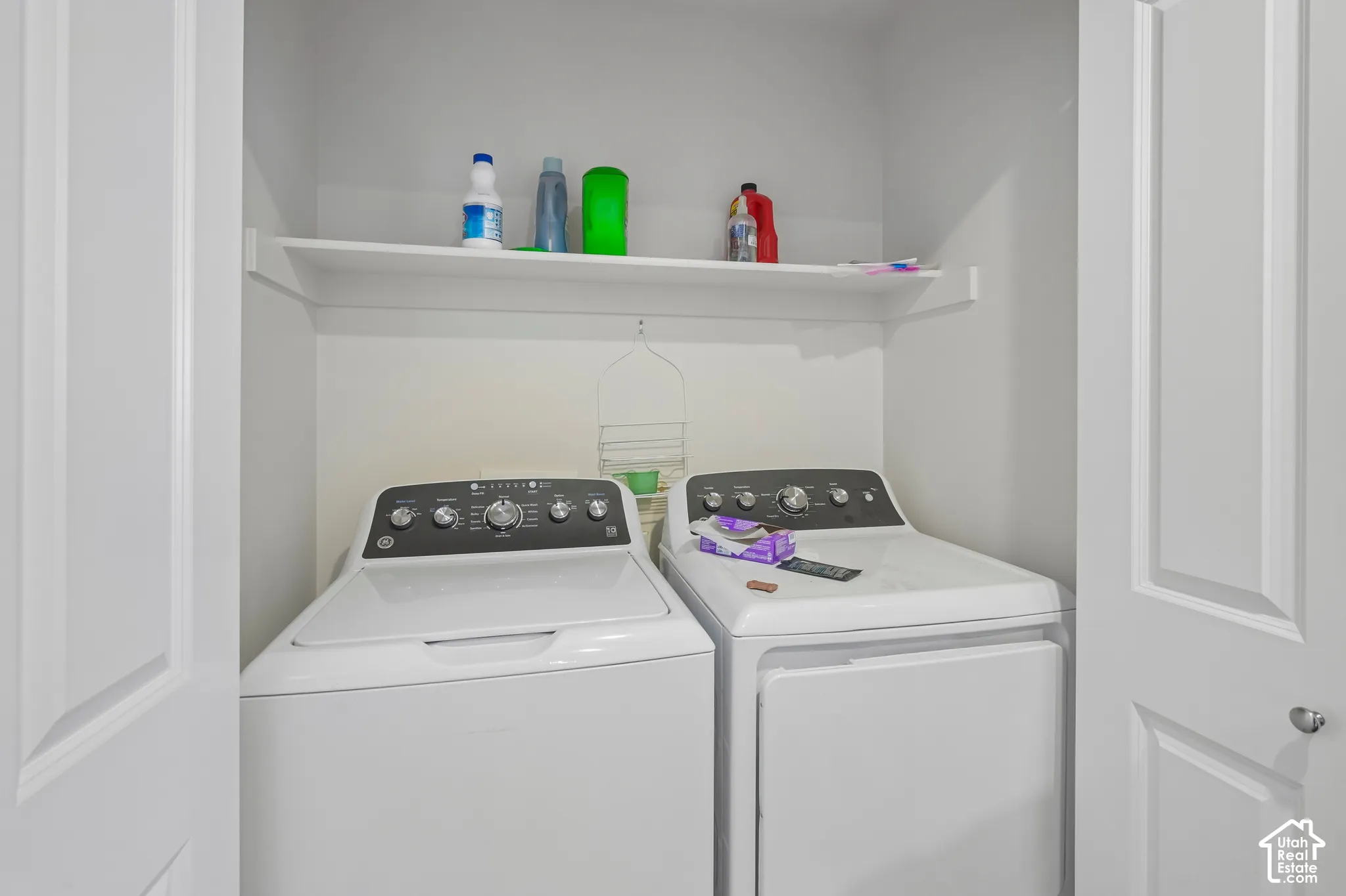 Laundry area with white walls and a built-in shelving unit