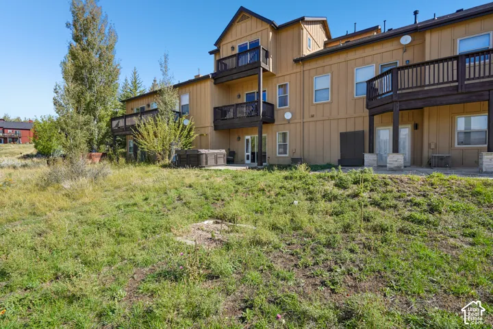 Multi-level exterior with multiple balconies and ground-level patios