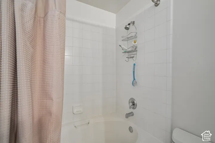 White subway tile tub surround with a built-in soap dish
