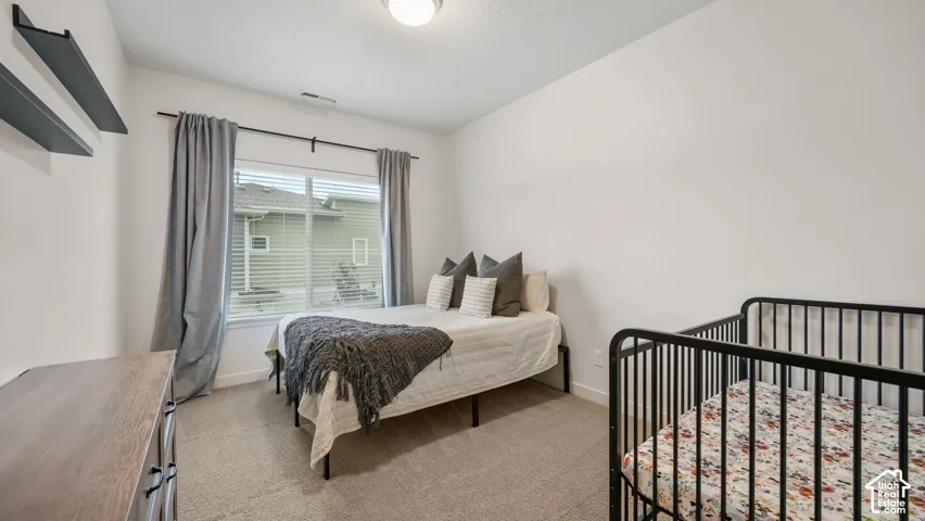 Neutral wall color, wall-to-wall carpeting, window with blinds and drapes, and overhead lighting