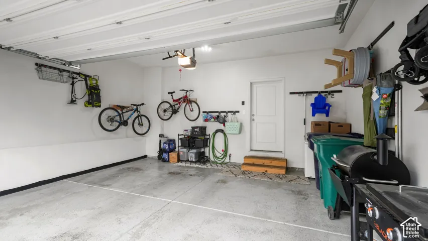 Finished garage with painted walls and an interior access door