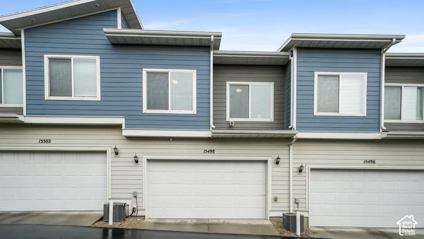 Exterior featuring modern siding, multi-pane windows, and attached garage