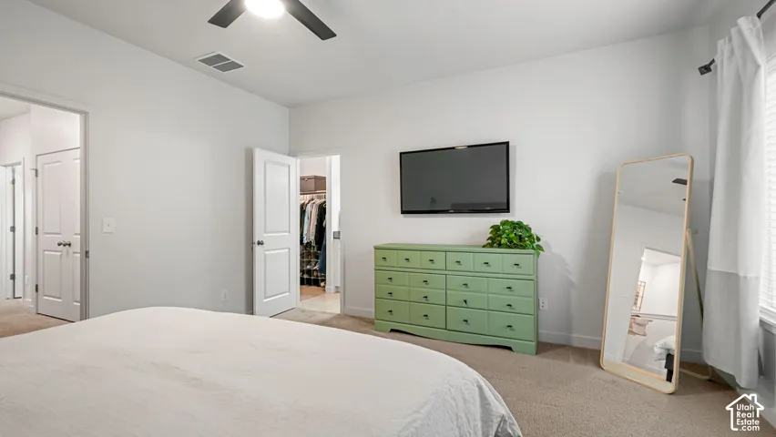 Recessed lighting, ceiling fan, neutral carpet, white paneled doors, and a built-in closet with shelving