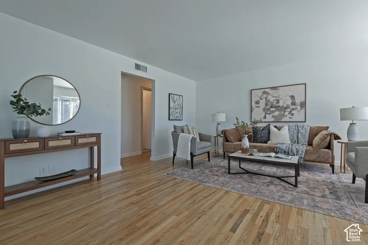 Hardwood flooring throughout, bright white wall finishes, and an open doorway