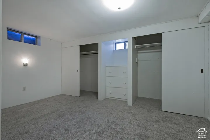 Wall-to-wall carpeting and built-in closet storage with sliding doors