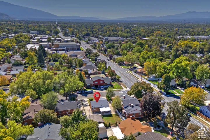 Expansive neighborhood with established trees, and distant mountain backdrops