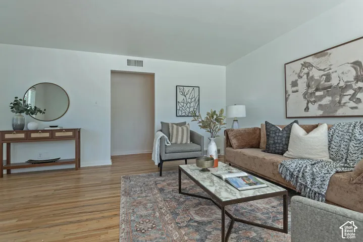 Hardwood flooring throughout, with light-toned walls and an open archway