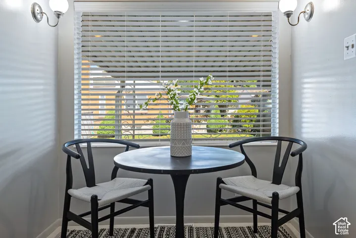 Window with horizontal blinds, flanked by two wall sconces