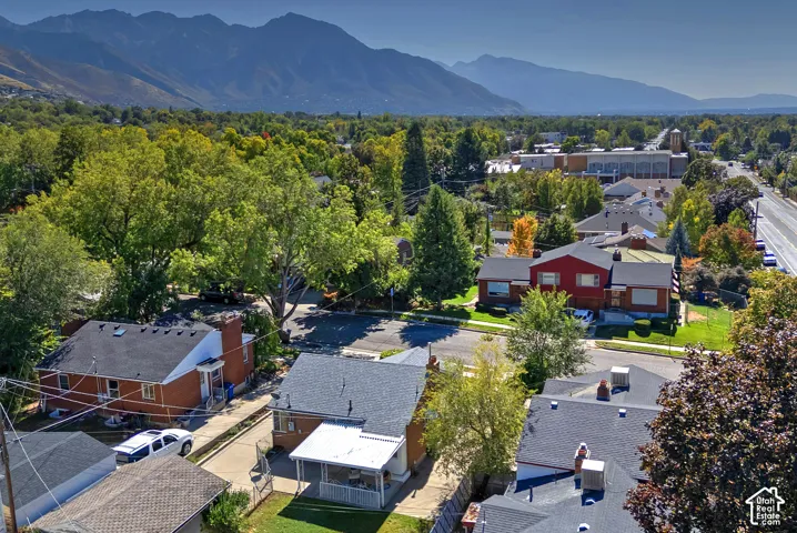Expansive surrounding landscape featuring distant mountains and mature trees