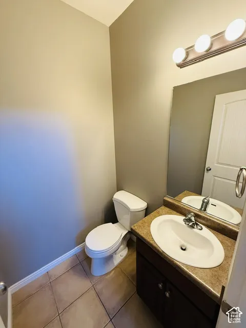 Vanity with a surface-mounted sink, warm-toned countertop, and dark wood-finish cabinetry