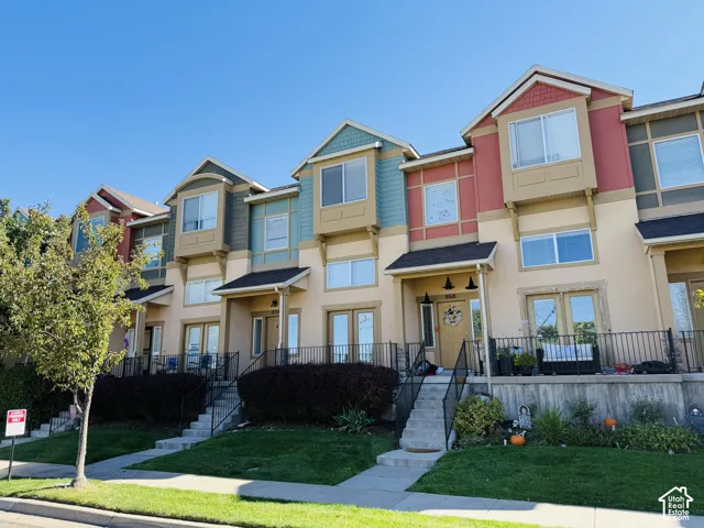 Stucco exterior featuring varied siding accents, covered entryways, and multiple windows