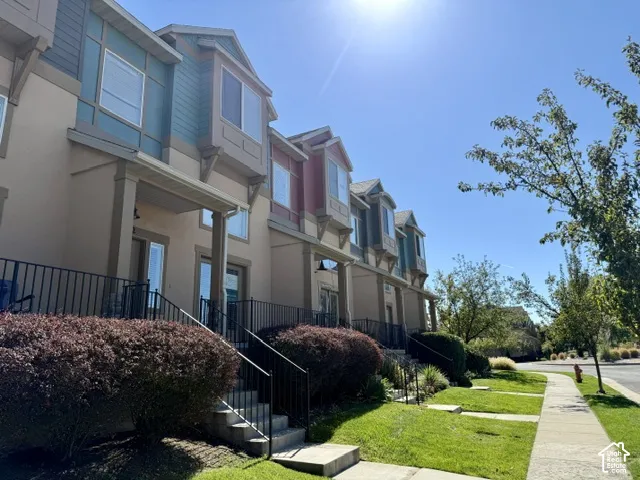 Contemporary townhome-style residences featuring bay windows and varied accent siding