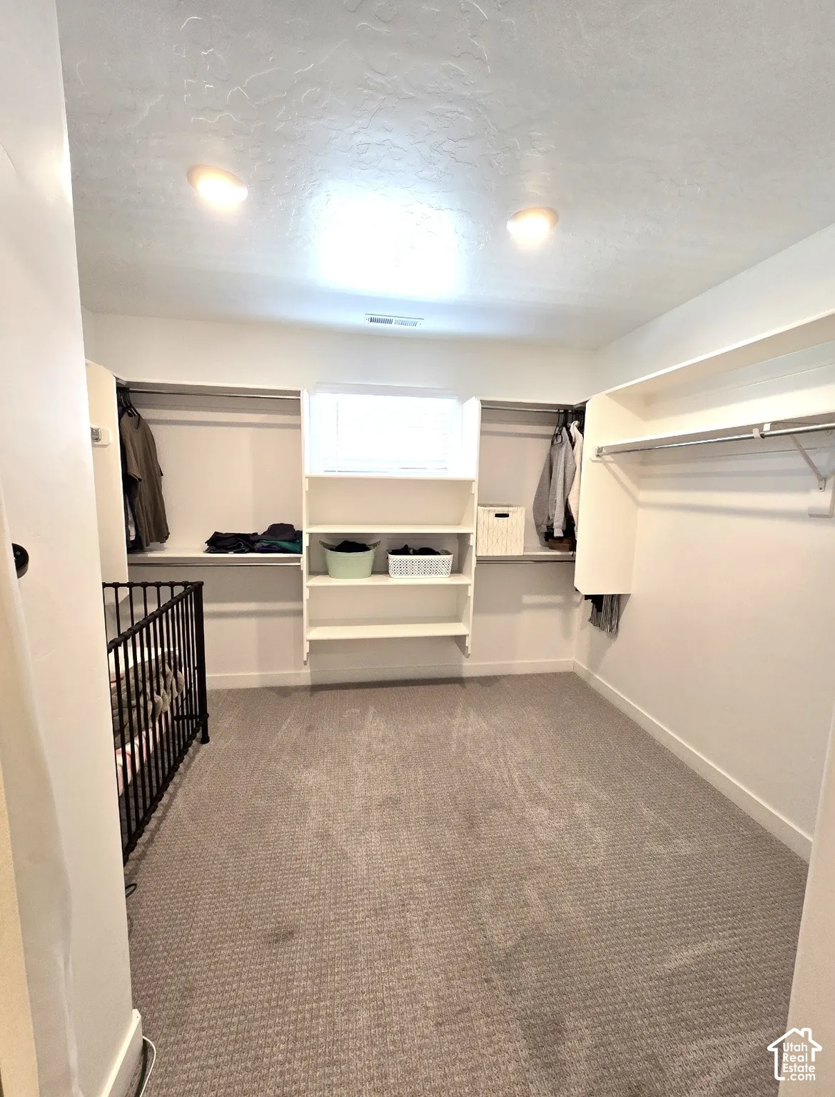 Built-in closet organization with shelving, hanging rods, and integrated cabinetry