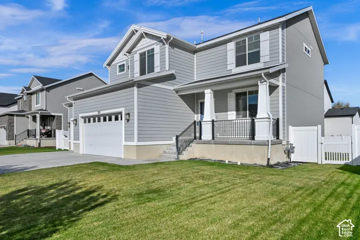 Two-story residence featuring light gray siding and white trim
