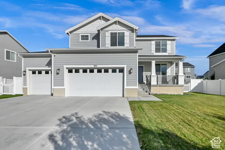 Light gray siding exterior with white trim, a three-car garage, and a covered porch