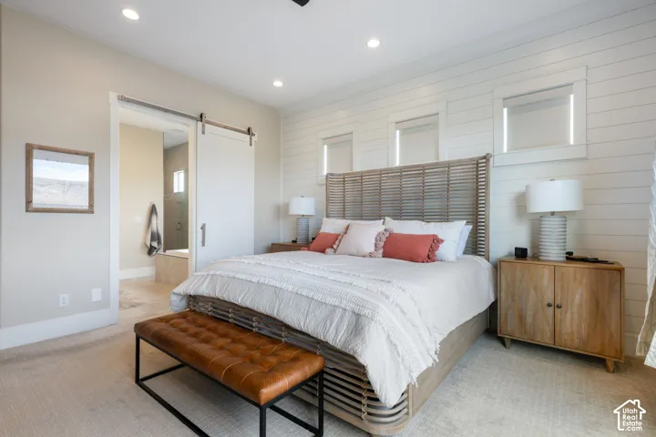 Recessed lighting throughout, shiplap accent wall, and wood-finish flooring