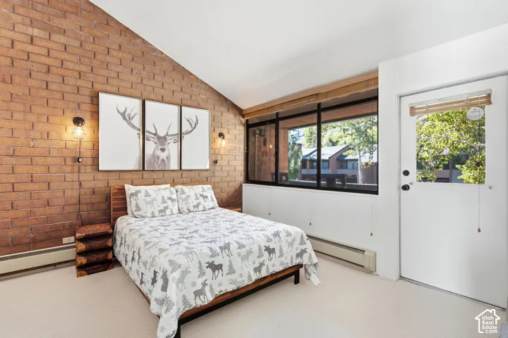 Exposed brick accent wall with wall-mounted lighting