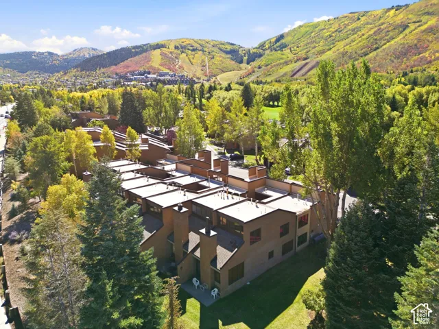 Terraced multi-story residences with flat roofs, multiple chimneys, and integrated private patios