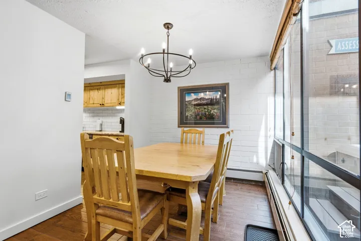 Wood-finish flooring with a white brick accent wall