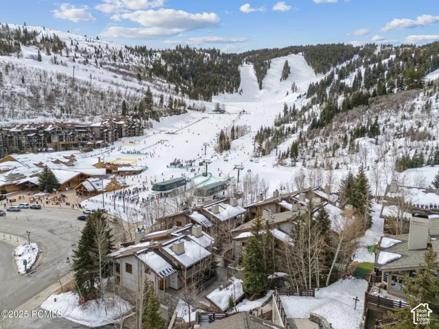 Aerial perspective showcasing ski resort environment with multiple slopes and chairlifts