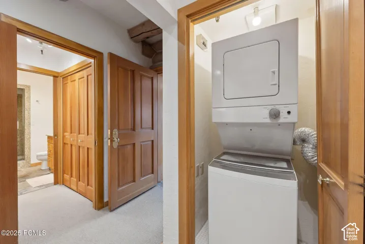 Stackable laundry appliances within a dedicated alcove