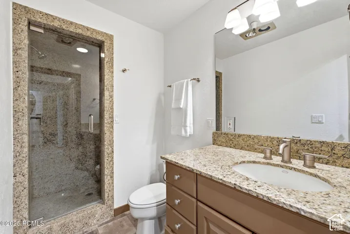 Shower with glass enclosure and stone surround