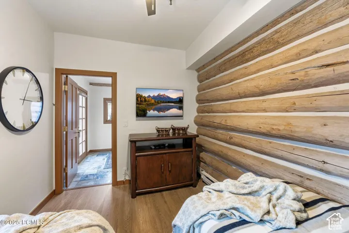 Wood-finish flooring and a natural wood log wall accent
