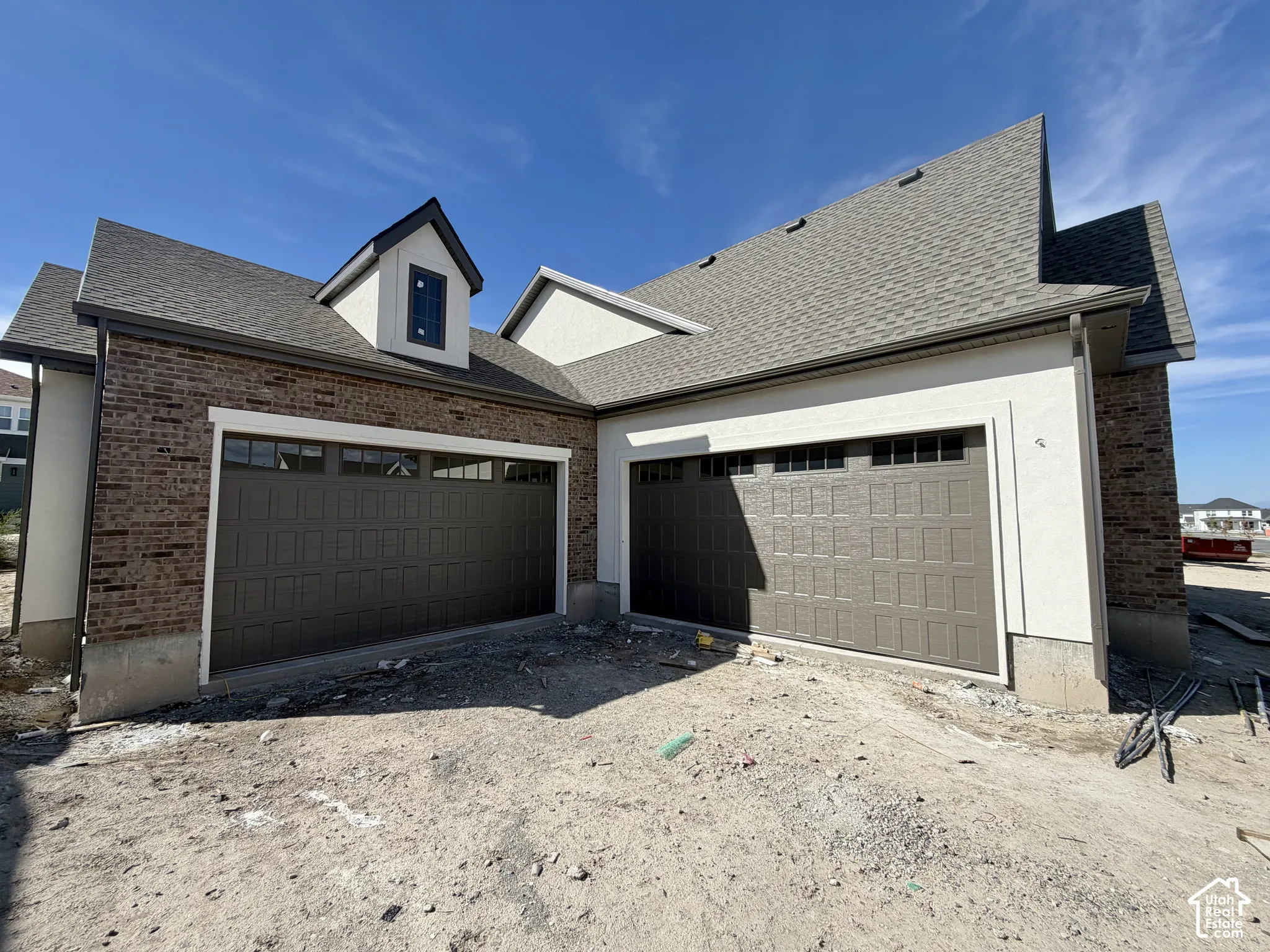 Brown brick exterior with light-colored stucco accents