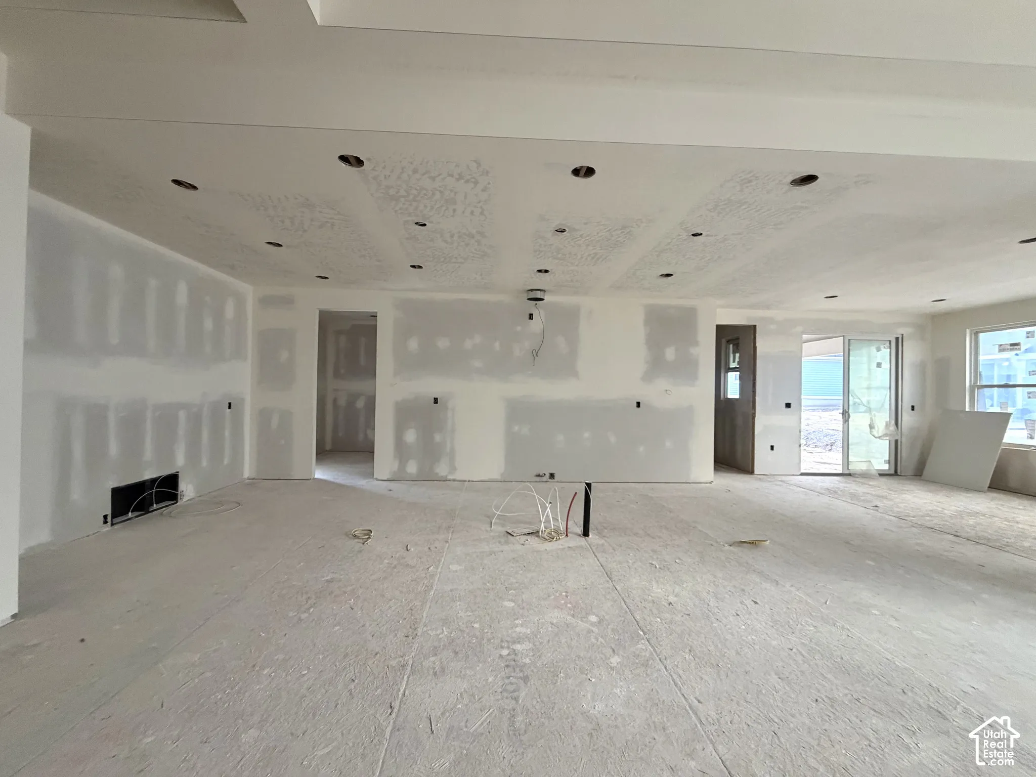 Recessed lighting, tray ceiling, sliding glass door, and large window