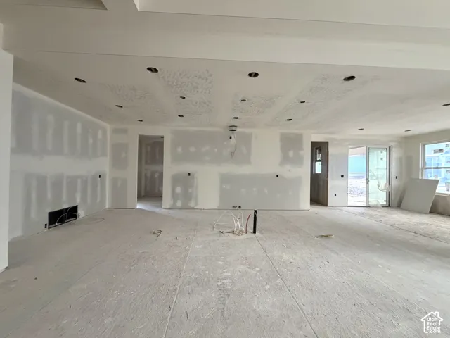 Recessed lighting, tray ceiling, sliding glass door, and large window