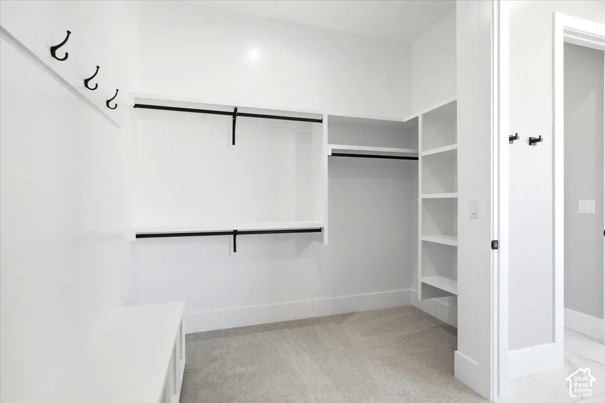 Built-in storage solutions featuring shelving, hanging rods, and a bench