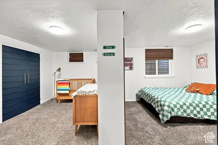 White walls with recessed window, dark wood-finish blinds, and a built-in wall partition