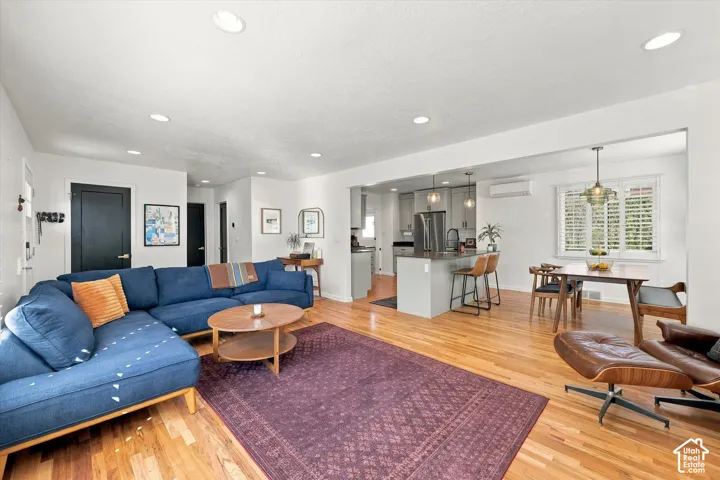 Hardwood flooring throughout, recessed lighting, and white walls