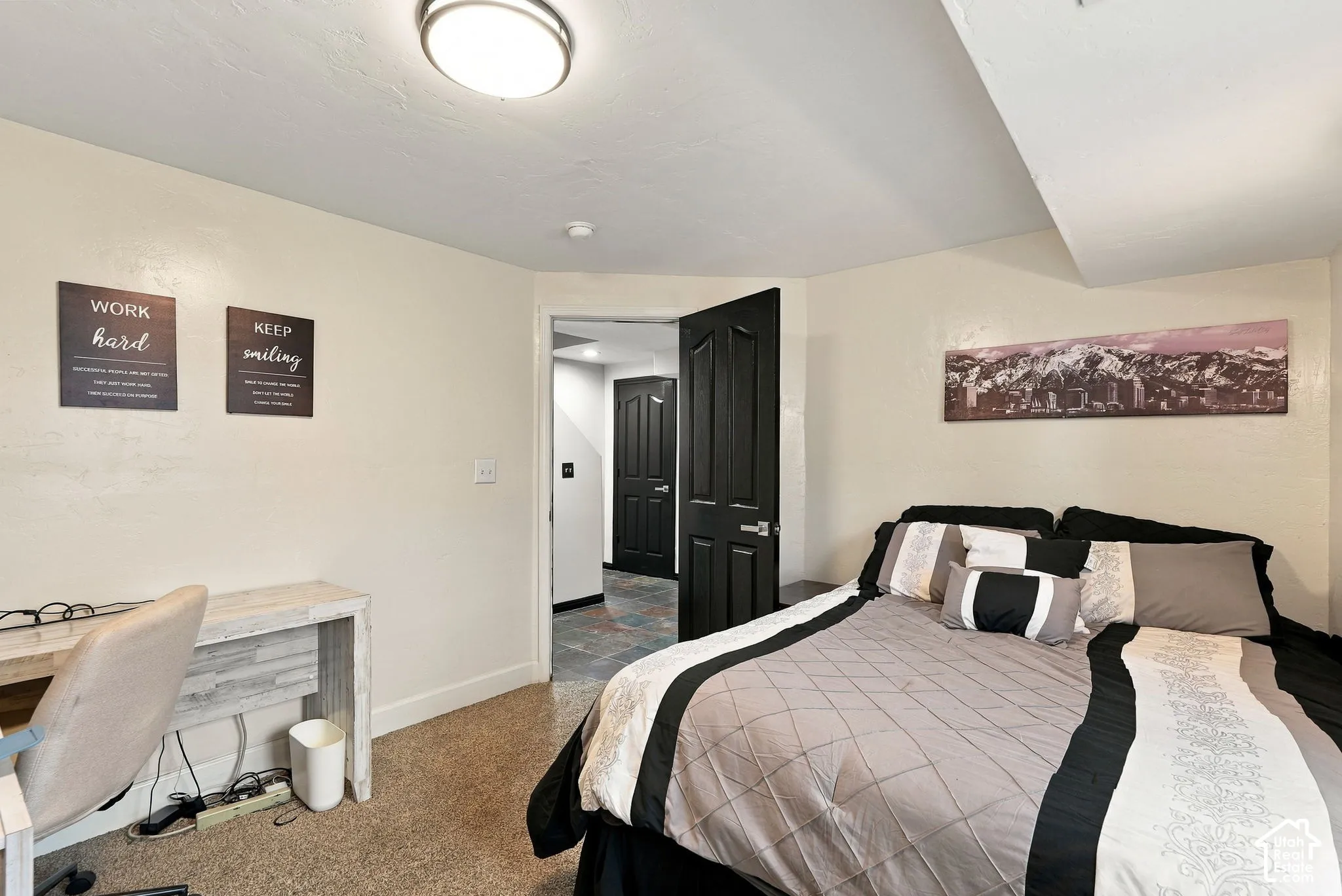 Recessed lighting, dark paneled doors, and light-toned walls