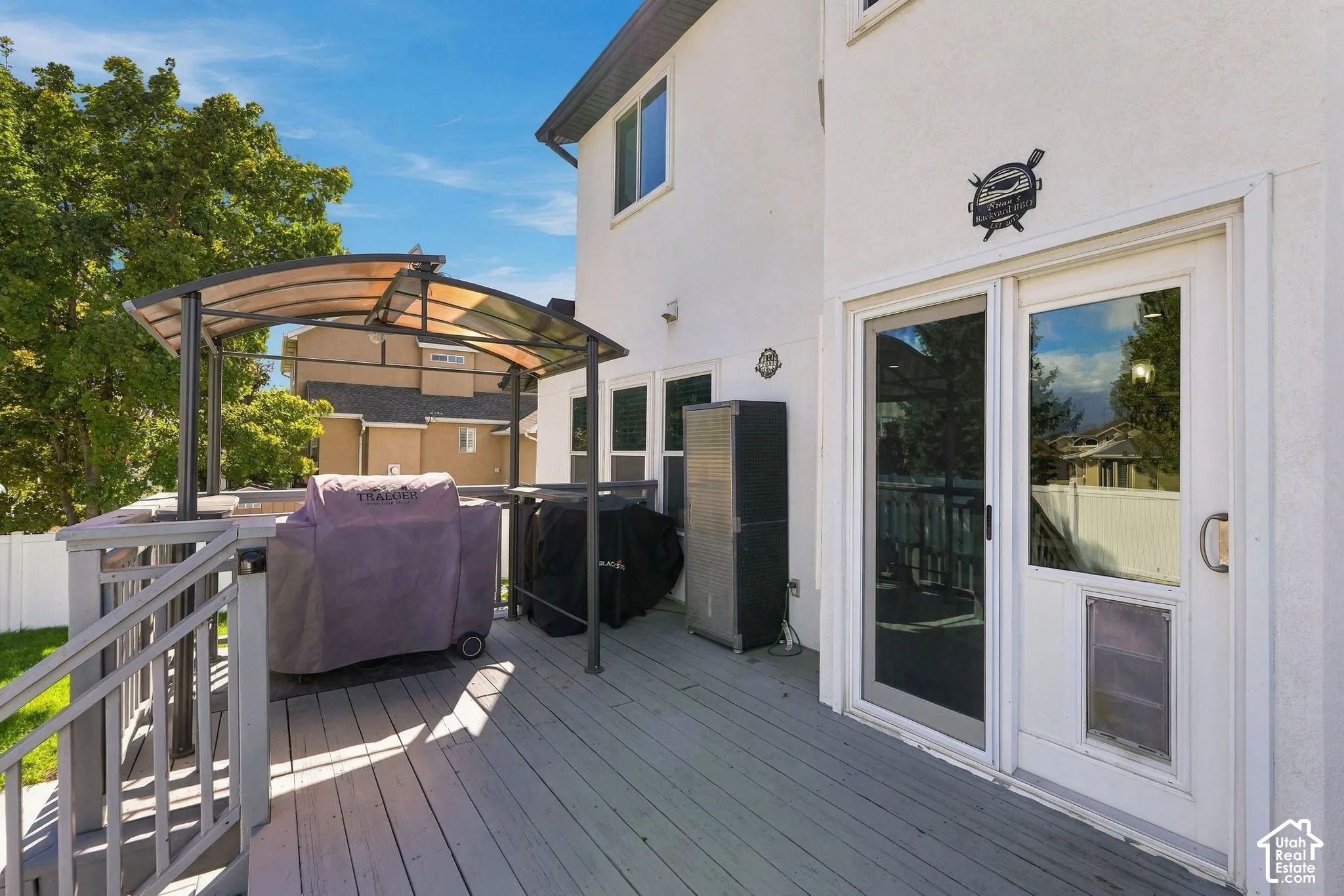 Spacious outdoor deck with a built-in pergola, offering direct access to the interior through a sliding glass door