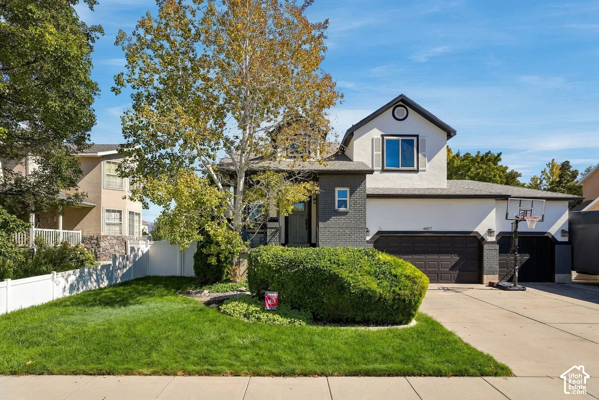 Stucco and brick exterior with dark trim accents