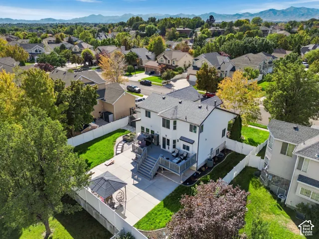 Spacious backyard featuring a multi-level deck, concrete patio, and manicured lawn areas