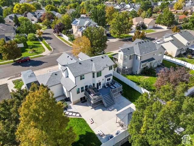 Expansive rear deck with multiple levels, concrete patio, and a grass lawn