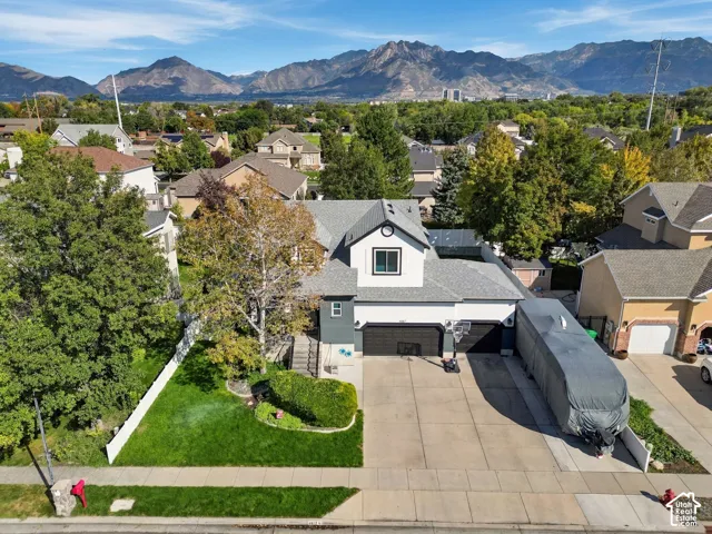 Two-story property with an attached two-car garage, concrete driveway, and front lawn